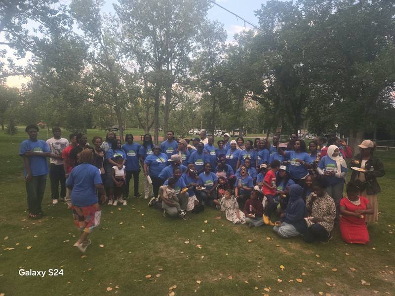 SALDAC members and families in blue T-shirts under the trees at the 2025 Picnic in the Park