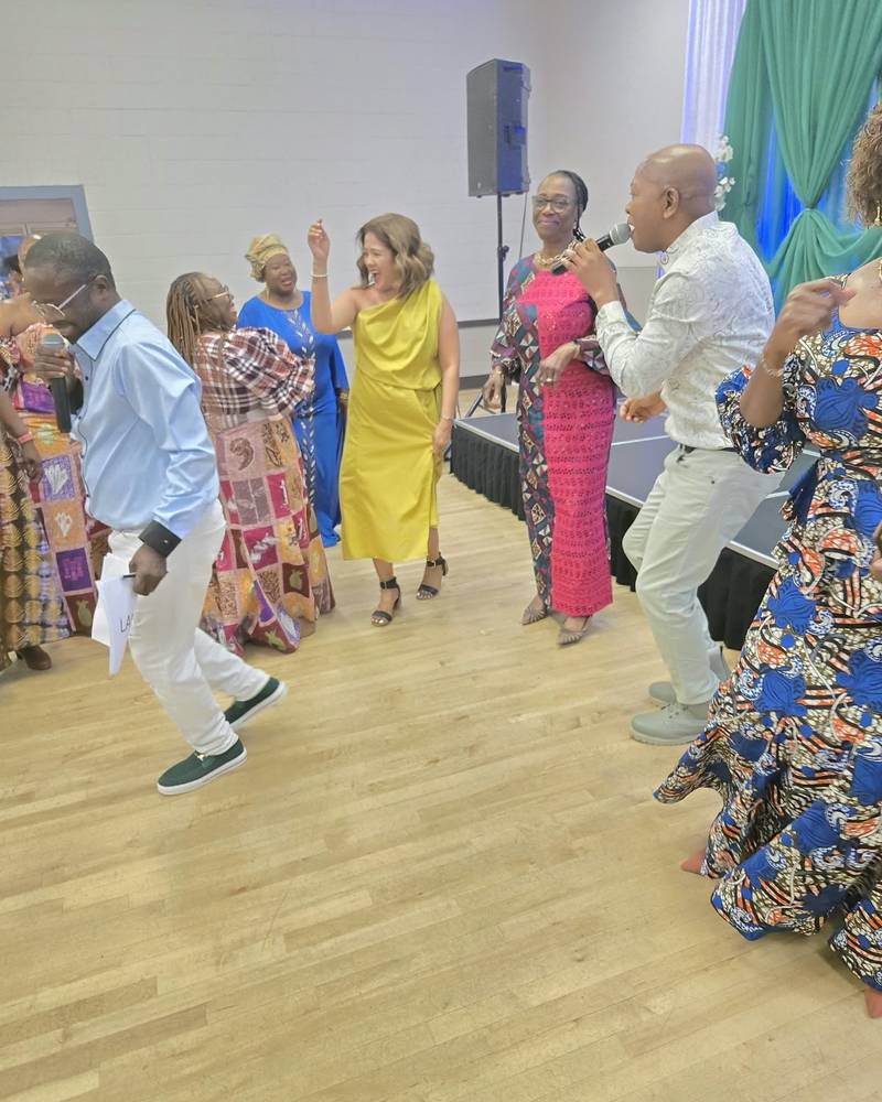 Guests dancing on the hall floor while a singer performs at SALONE@65