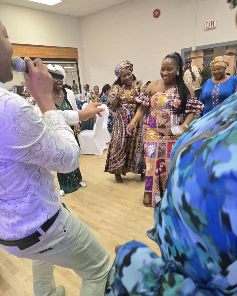 A singer with a microphone leads the dancing at SALONE@65