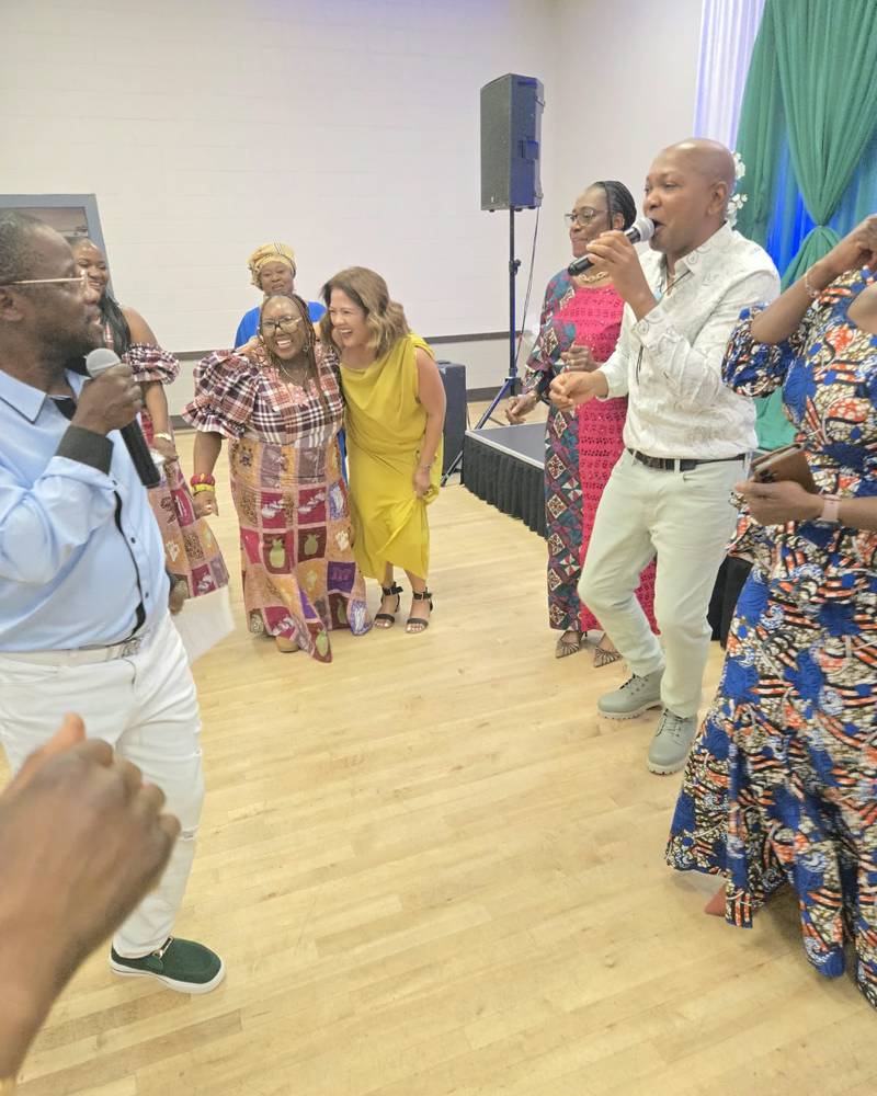 Two singers with microphones and guests dancing at SALONE@65